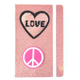 Rond Roze Peace Teken Strijk Embleem samen met een reversible pailletten hart strijk embleem op een roze glitter agenda
