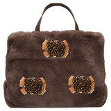 Drie maal de Rozet Strik Opnaai Fashion Part op een bruine fluffy tas